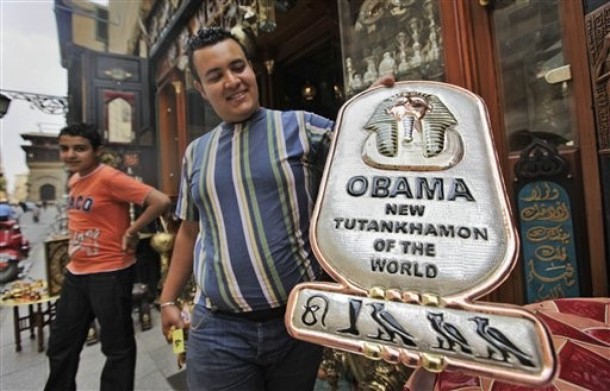 As Egypt prepares for the arrival of President Obama this week, a Cairo vendor displays a handmade copper plaque reading  'Obama, New Tutankhamun of the World.'